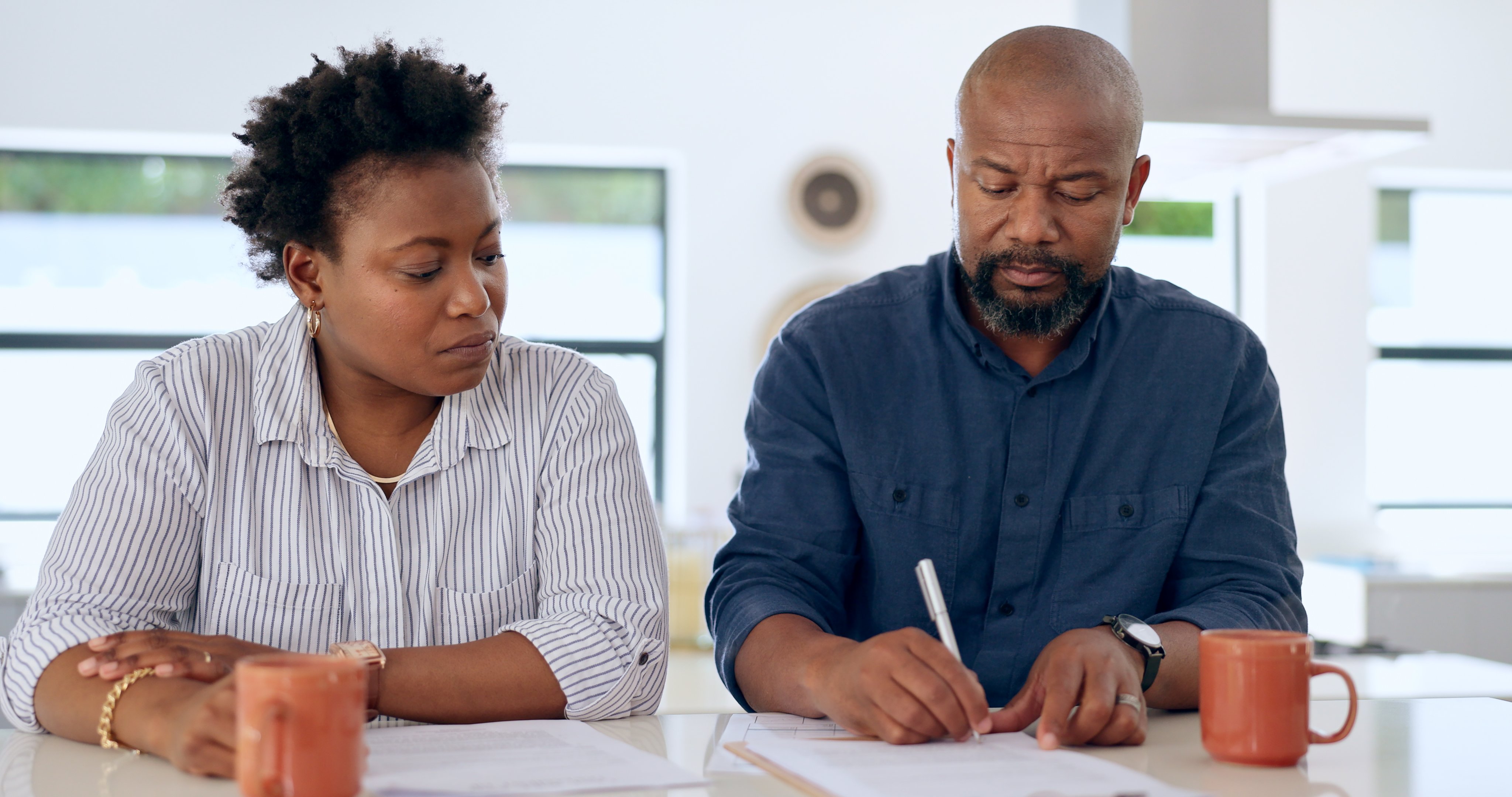 Couple, married and together with document in office for signature, paperwork or contract for insurance.