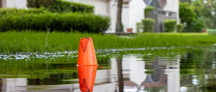 Water floods a residential neighborhood with houses and cars after a severe rain storm