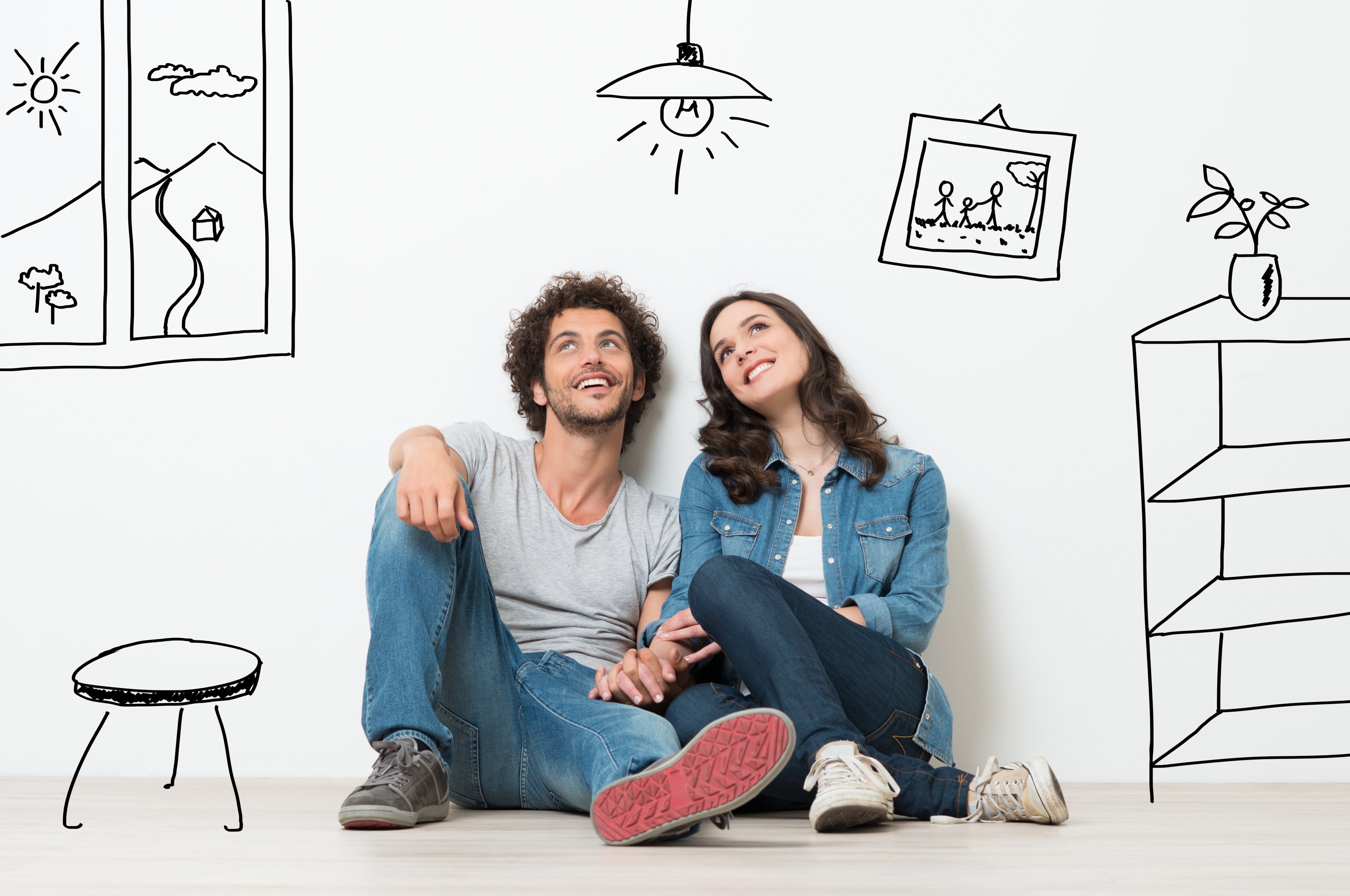 Couple sitting on the floor thinking about buying a house