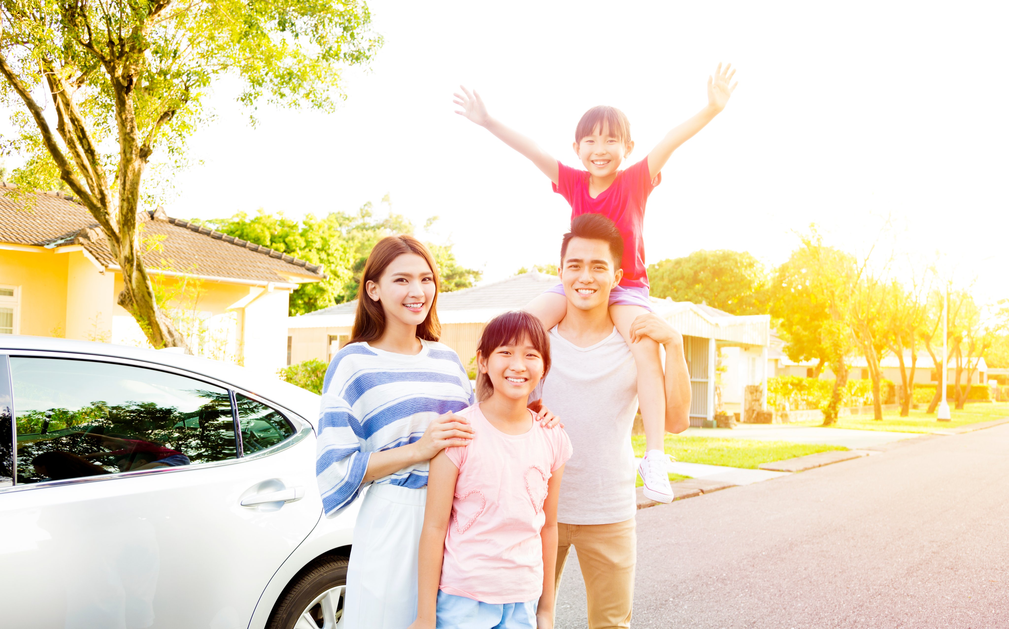 Beautiful happy family portrait outside their house