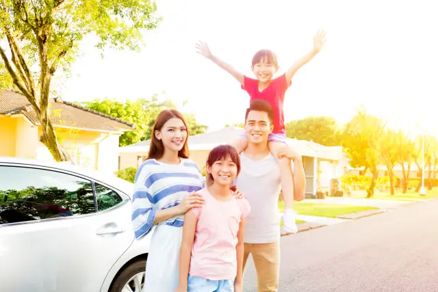Beautiful happy family portrait outside their house