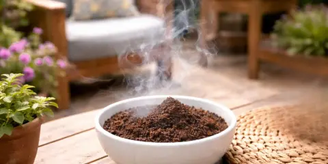 Coffee grounds smoldering to create smoke that helps repel mosquitoes