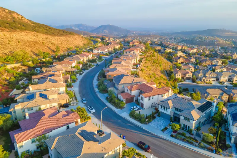 Aerial view of a California hillside suburban neighborhood along a winding street