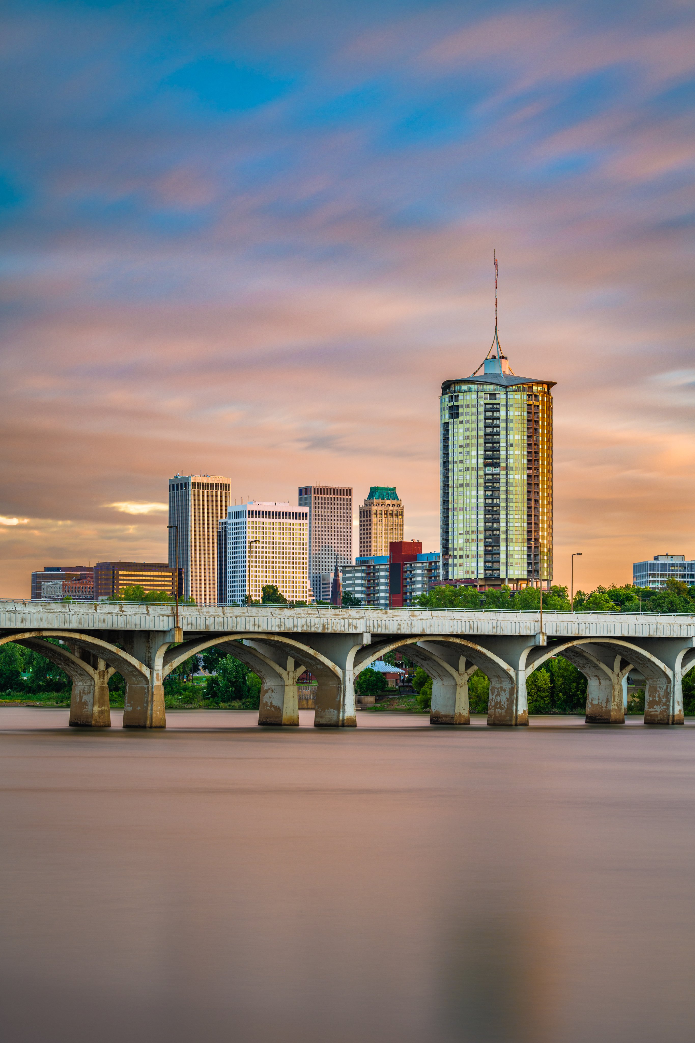 Tulsa, Oklahoma, USA downtown skyline on the Arkansas River at dusk.