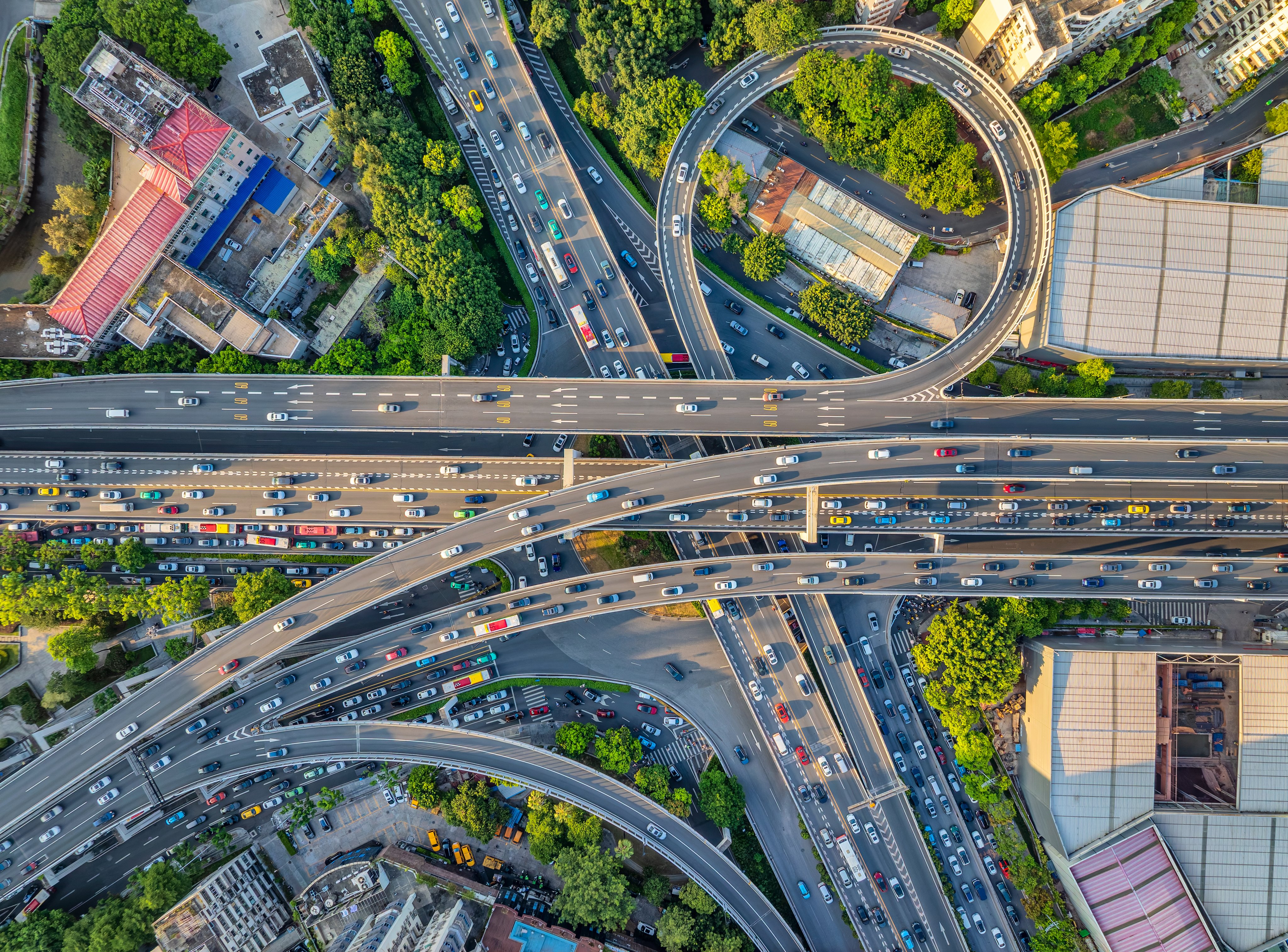 Intricate network of an urban highway interchange shows continuous streams of vehicles navigating through a modern metropolis.