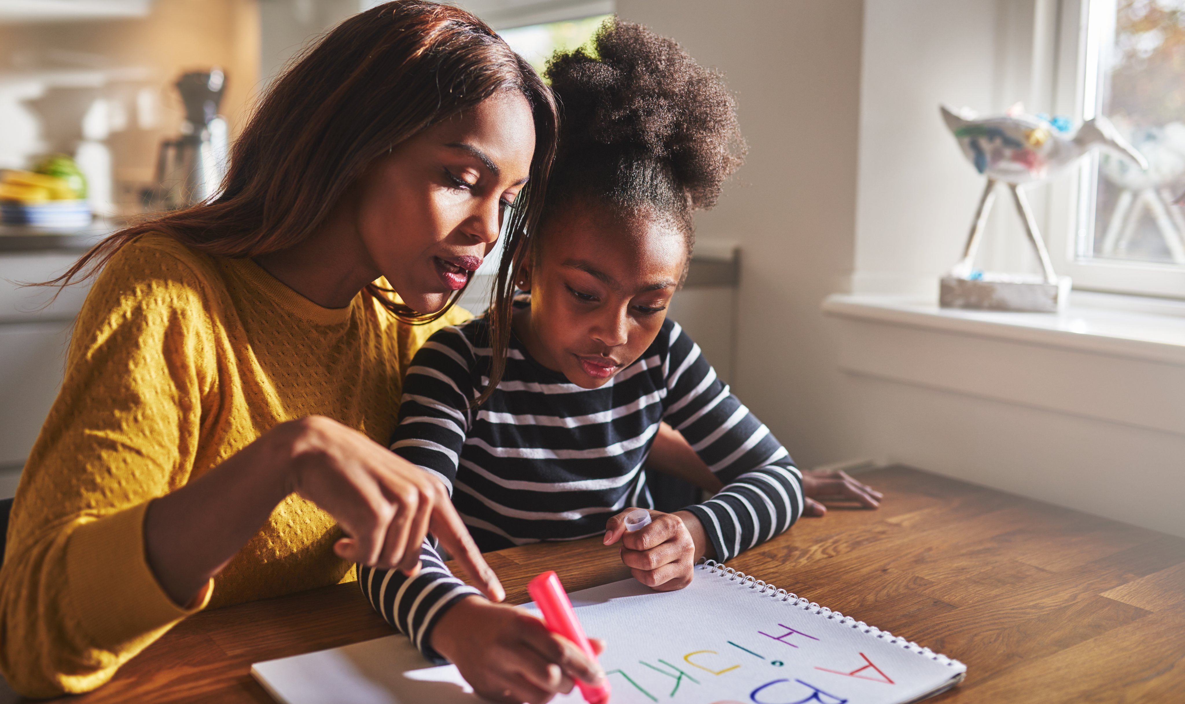 Mom helping daughter writing an emergency plan