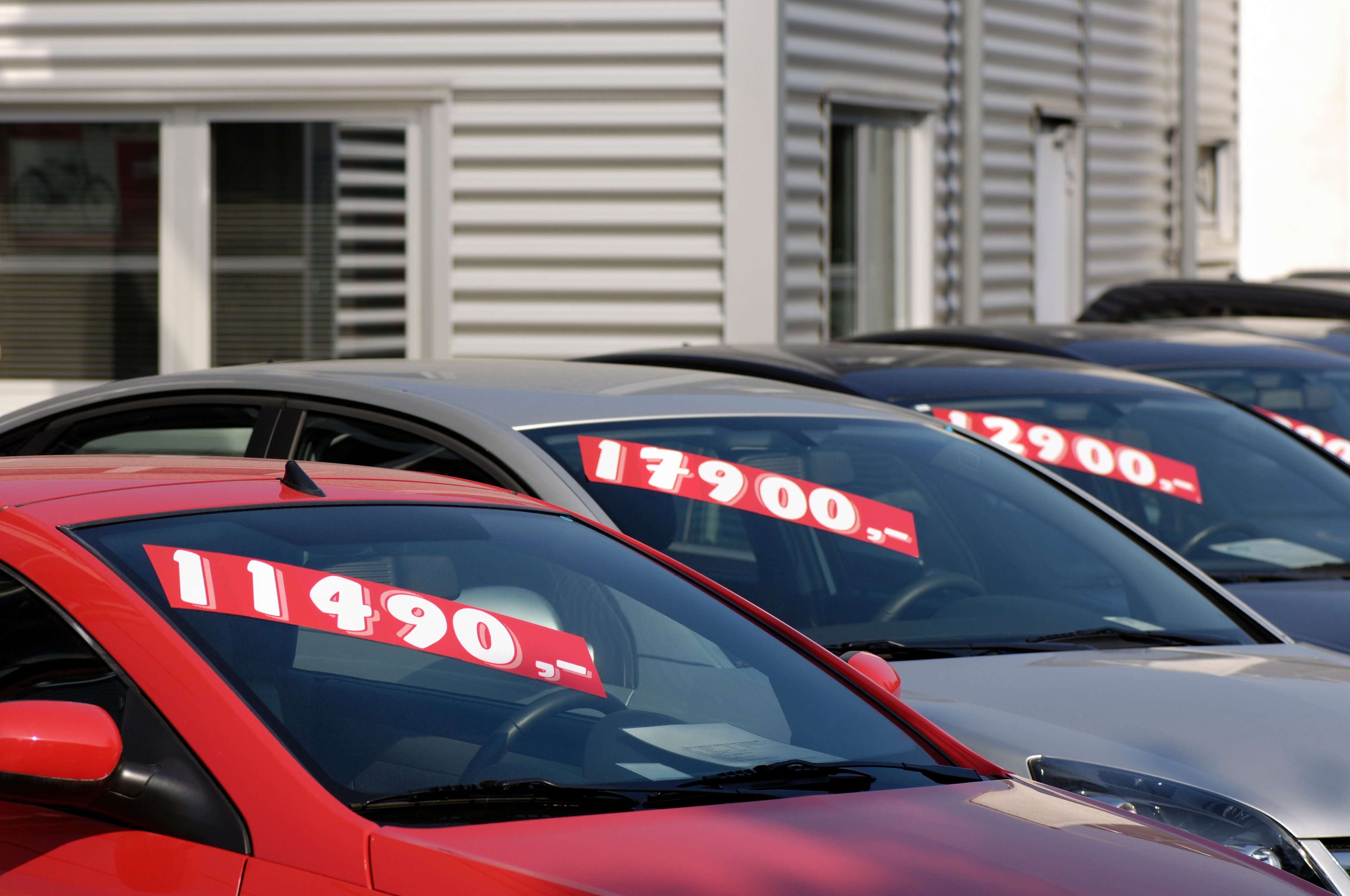 Row of used car with prices.