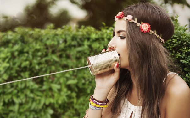Woman using a tin can phone