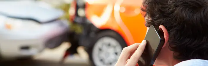 Teenage driver making phone call after traffic accident
