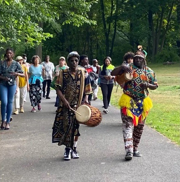 Yahaya Kamate and the Kamate Group leading concertgoers to the Enslaved Burial Ground in honor of Juneteenth.