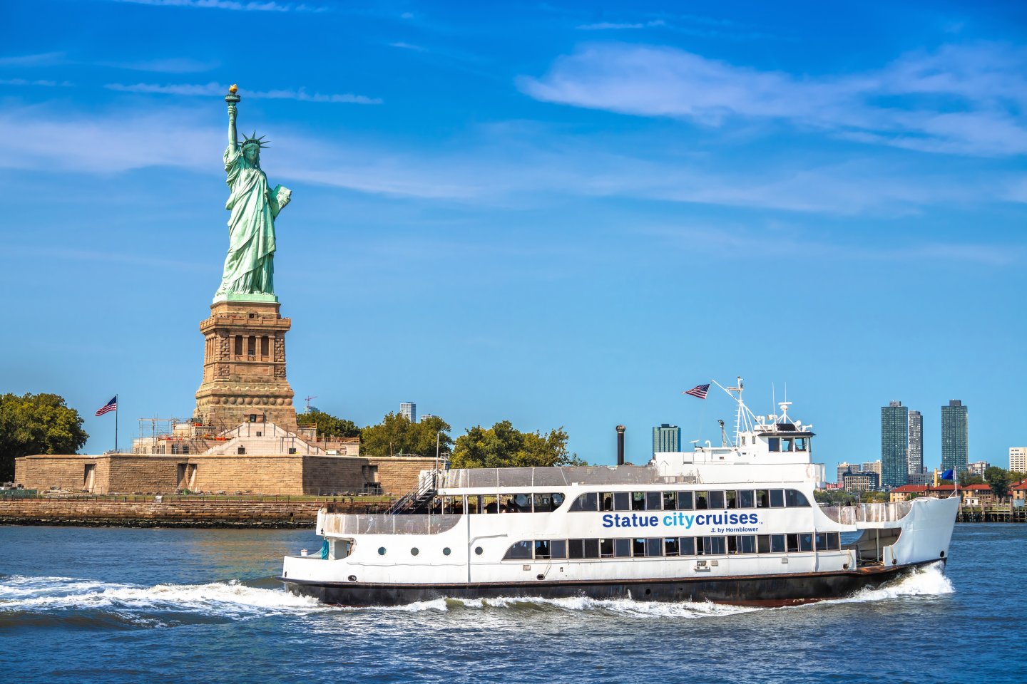 Statue City Cruises passing by Statue of Liberty