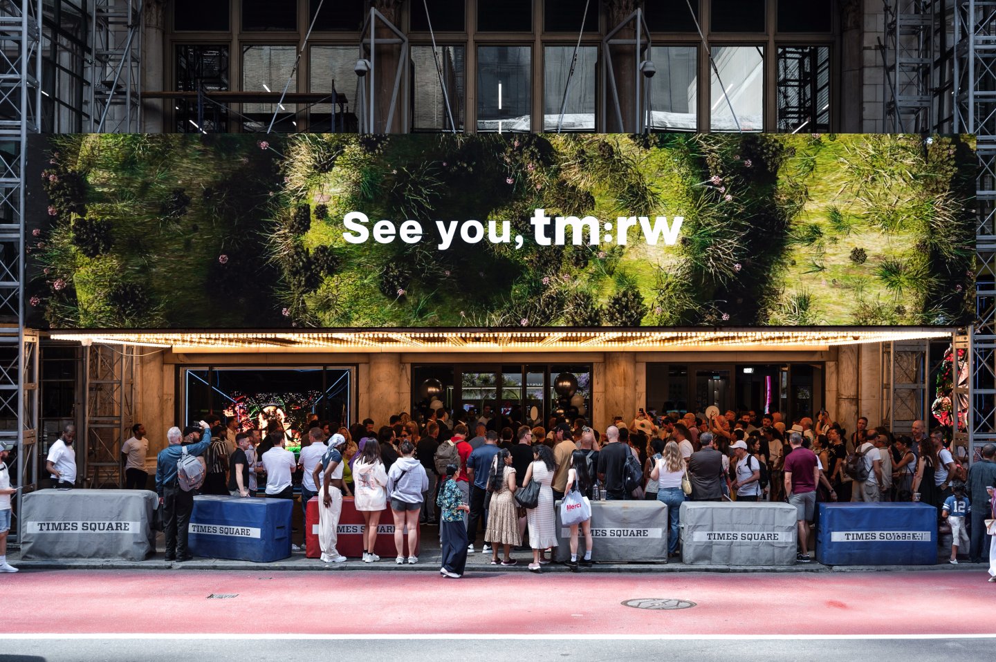 Exterior view of tm:rw in Times Square with digital marquee signage above the entrance.