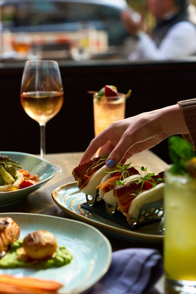 Pork belly bao buns, cocktails, and shareable plates are served at BLACKBARN, where guests can enjoy 26% off select appetizers such as bao buns, vegetable samosas, crispy chicken wings, and more.