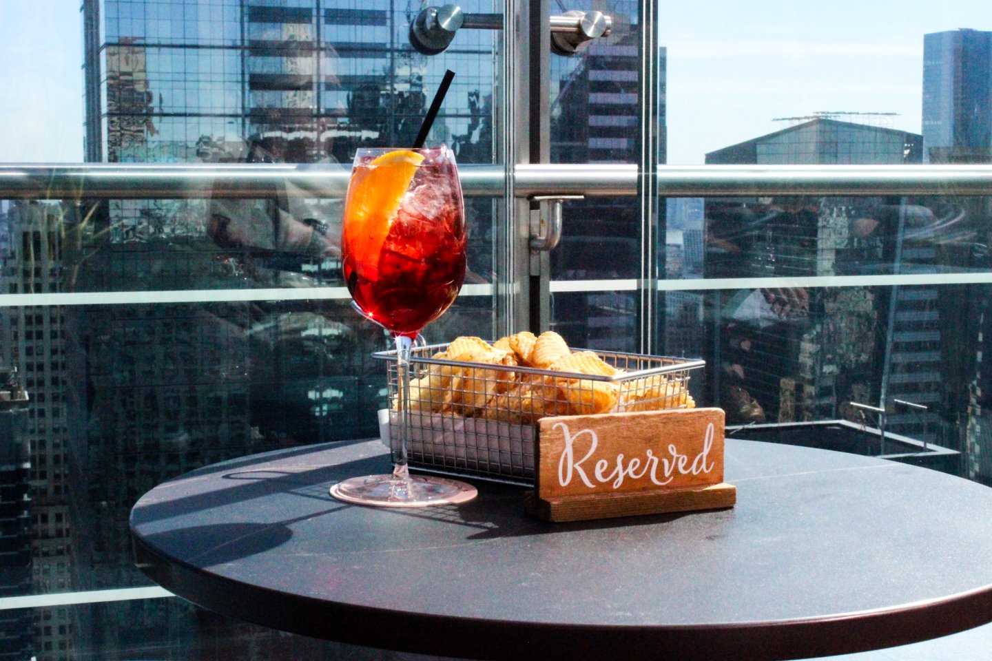 cocktails and chips at a city rooftop bar terrace