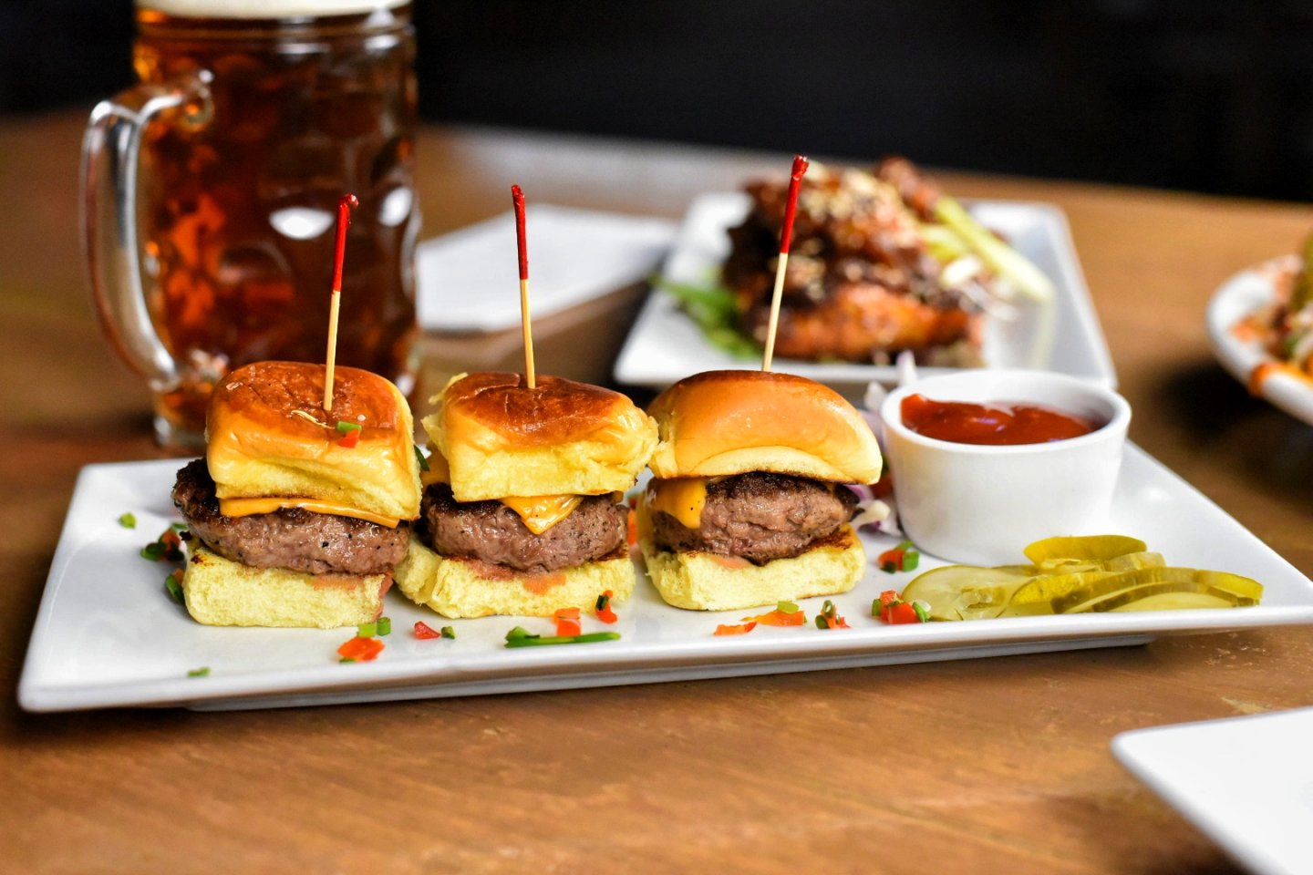 a beer and a plate of sliders