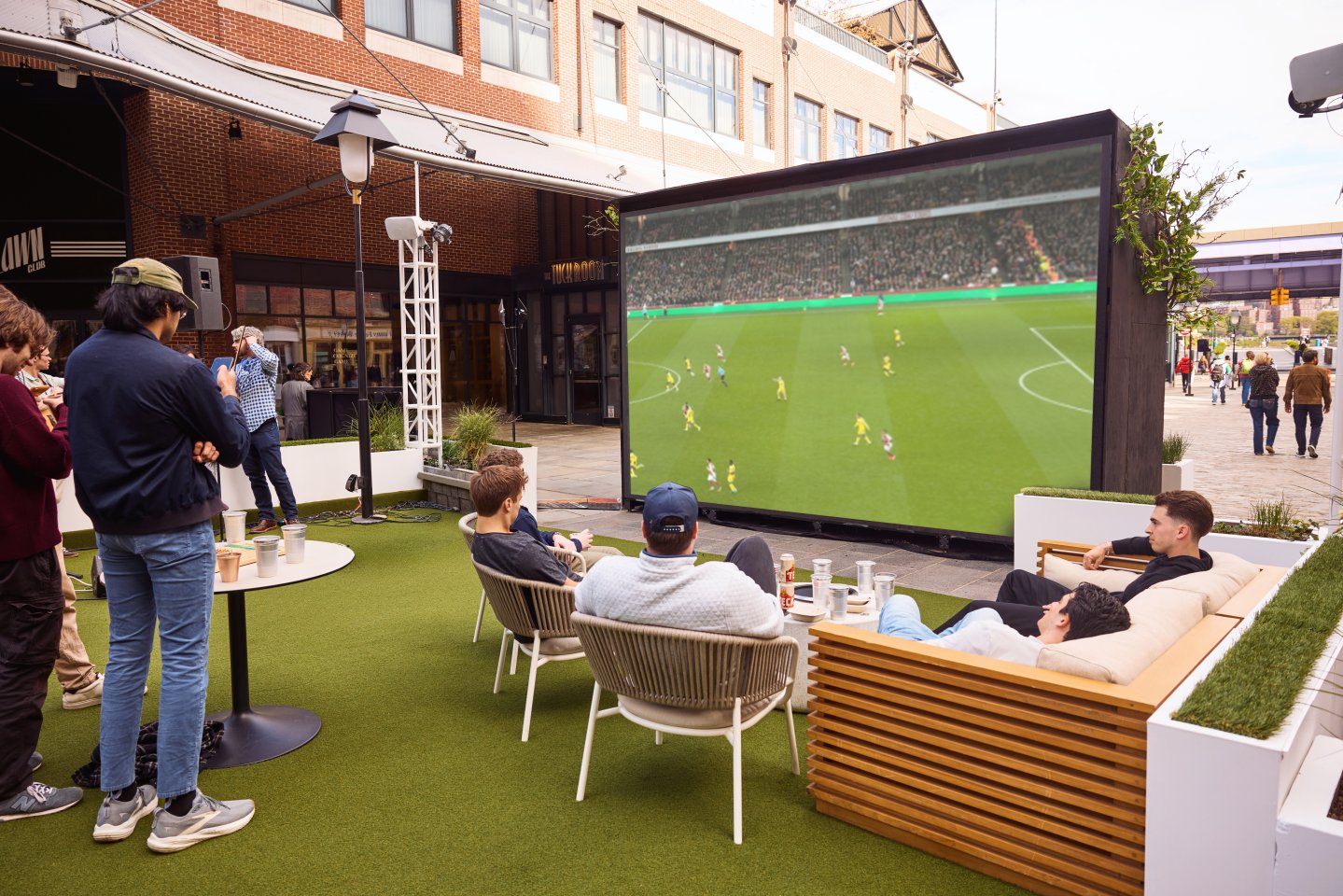 a group of young men watch the World Cup at Sadie's Garden Bar's 18 foot outdoor screen