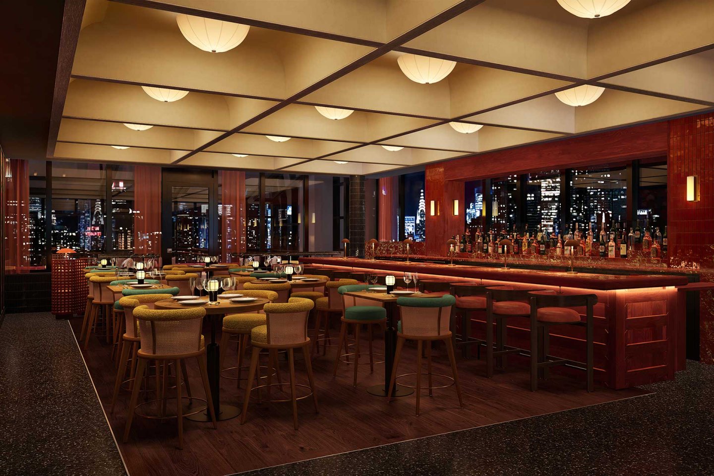 A modern restaurant bar with wooden tables, cushioned chairs, and a long bar counter. Warm lighting and large windows reveal a nighttime city skyline in the background.