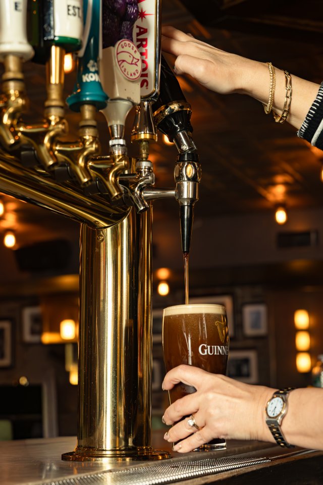 Photo at a bar of a guinness being poured for sport watching