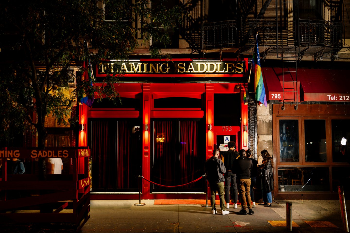 Folks lining up to enter Flaming Saddles in Hell's Kitchen