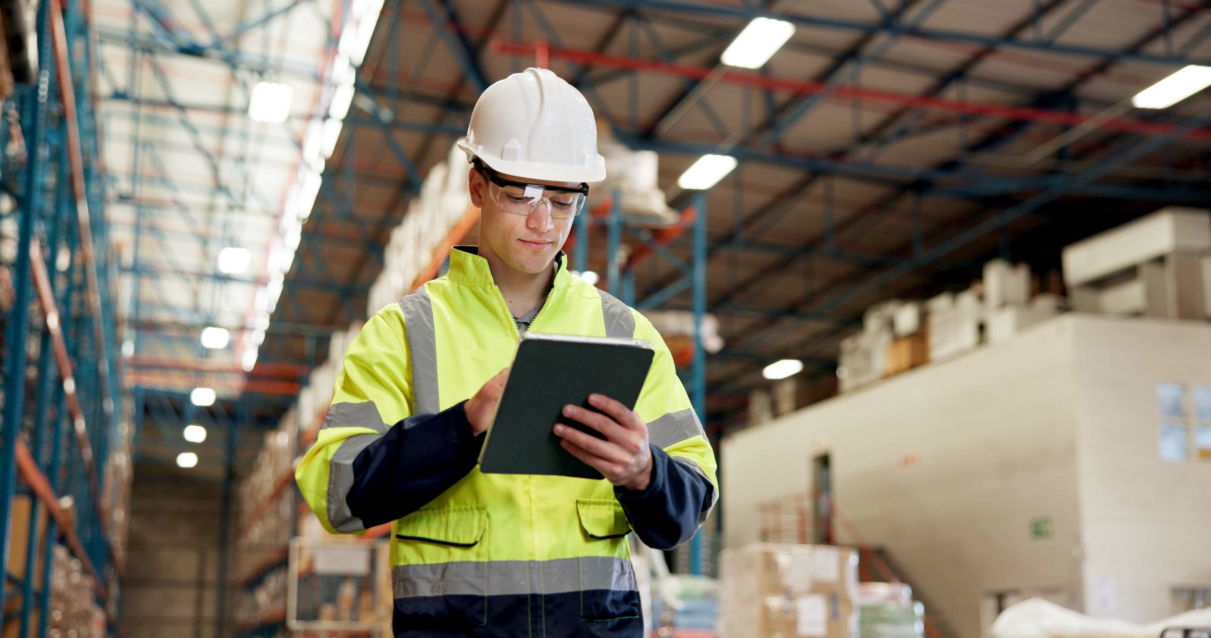 Businessman, logistics and checking inventory with tablet in warehouse for supply chain or stock. Man, distributor or supplier with technology for storage maintenance or quality control in depot.