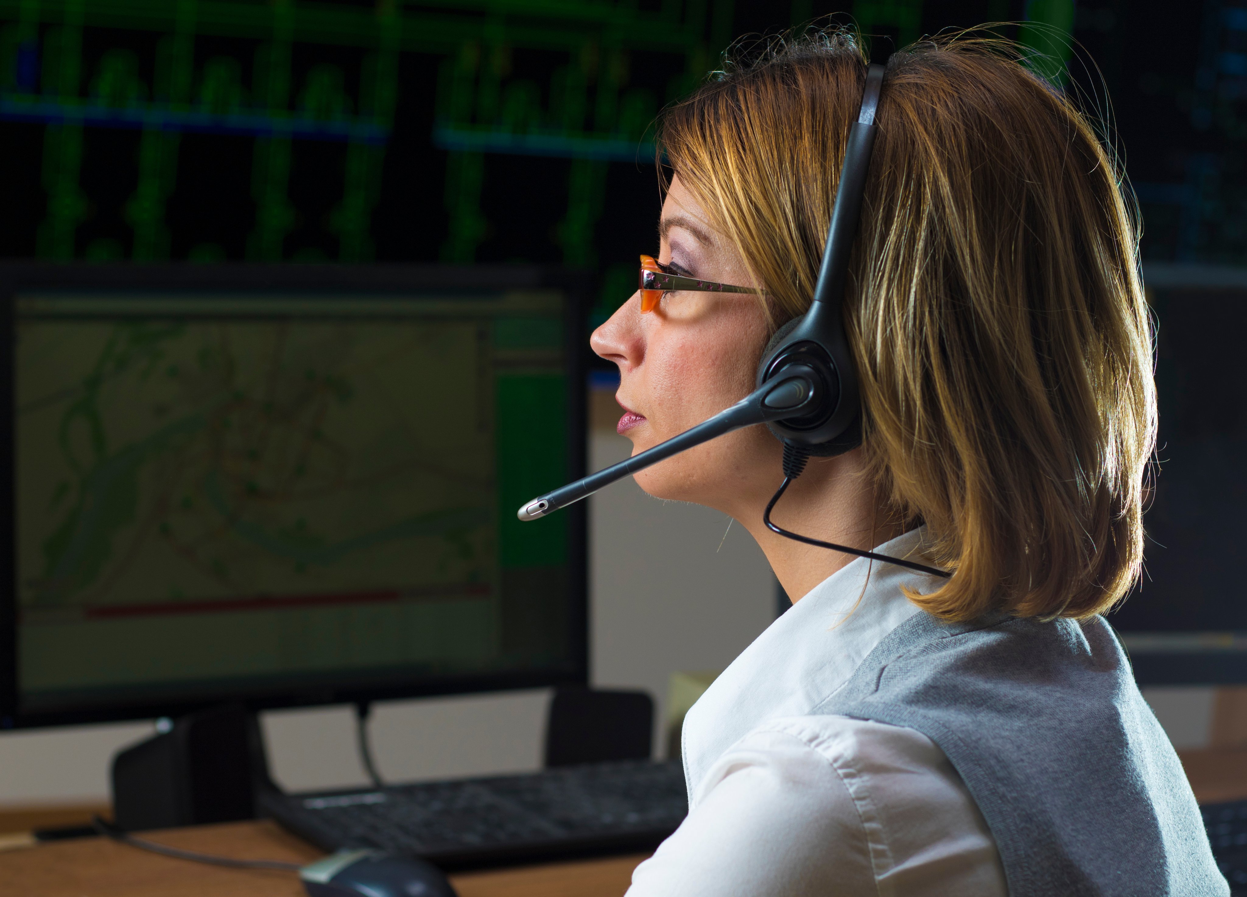 Dispatcher with headphone in power distribution control center