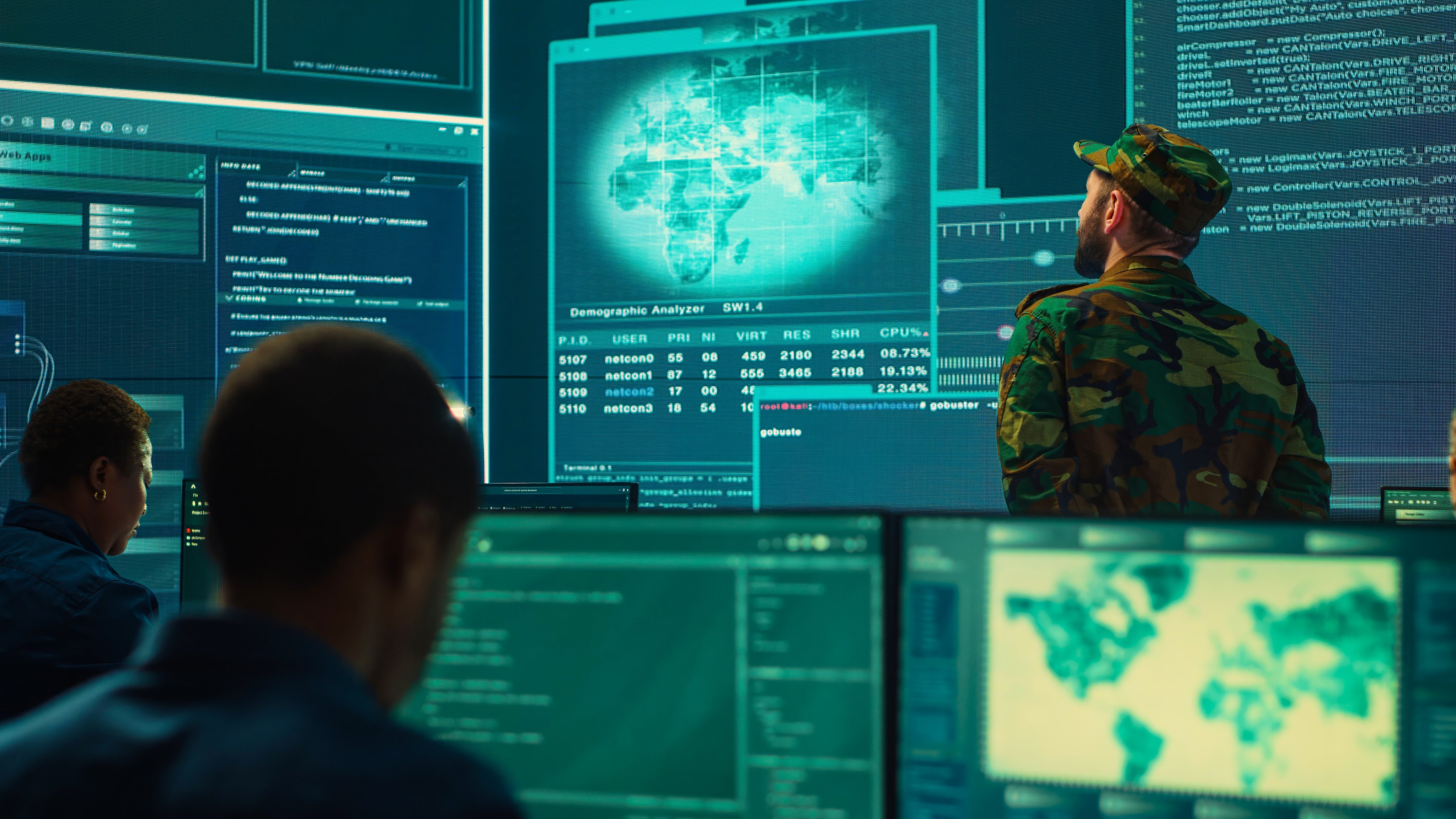 Military hackers working on cyber security in a high tech government center. Focusing on network protection, encryption and preventing cyber attacks to safeguard state secrets. Camera A.