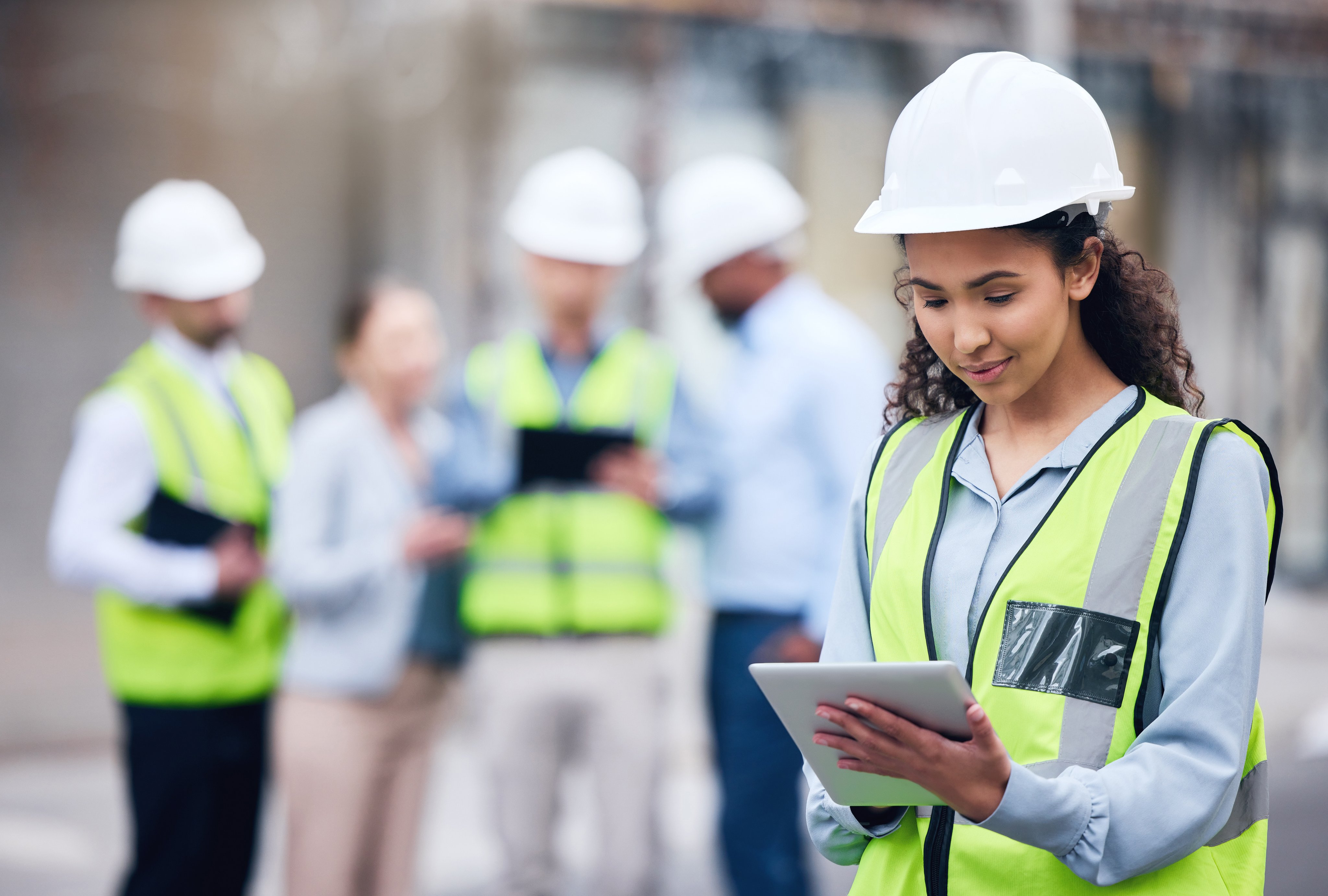 Business woman, architect and tablet in leadership, project management or inspection for construction on site. Female person, engineer or manager with technology and team for industrial architecture.