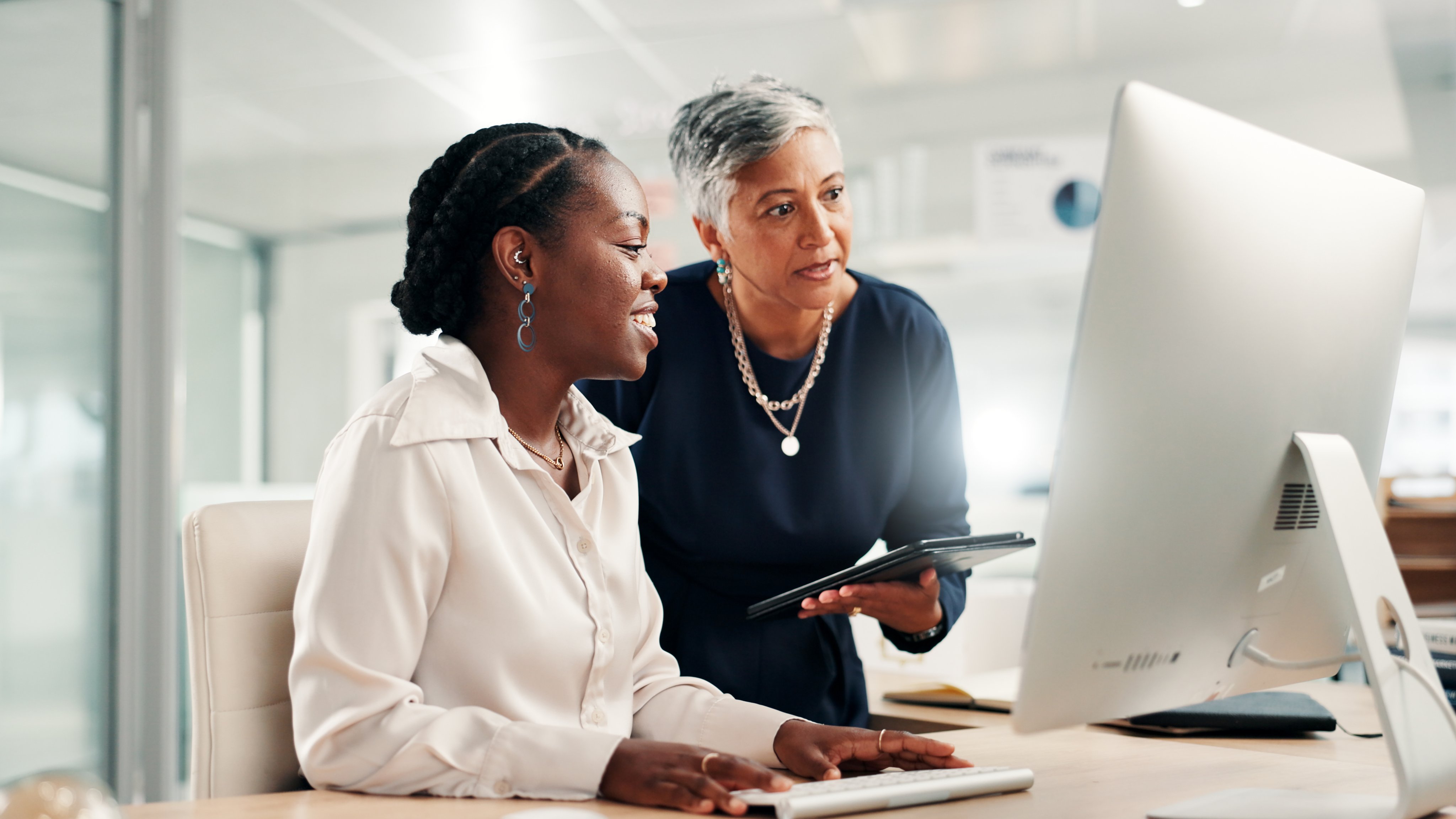 Computer, teamwork and review with business women in office for accounting discussion, audit feedback or talk. Tech, portfolio manager and collaboration with mentor, tablet and finance agency report.