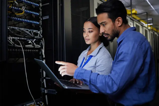 People, maintenance or laptop in server room, IT engineering or software programming ideas in cybersecurity. Repair woman, man or data center technology in teamwork collaboration for safety analytics.