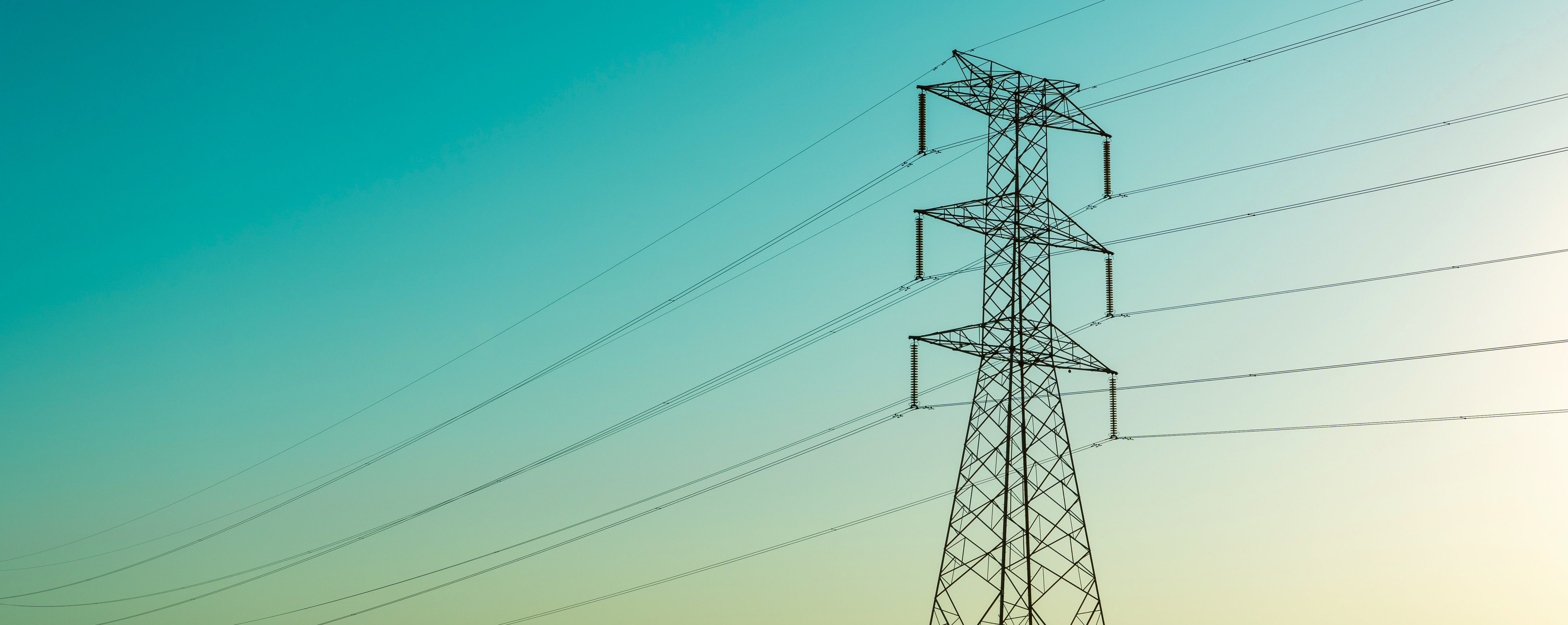 Tall electric towers stretch across the skyline, supporting high-voltage power lines. The structures are crucial for power transmission.