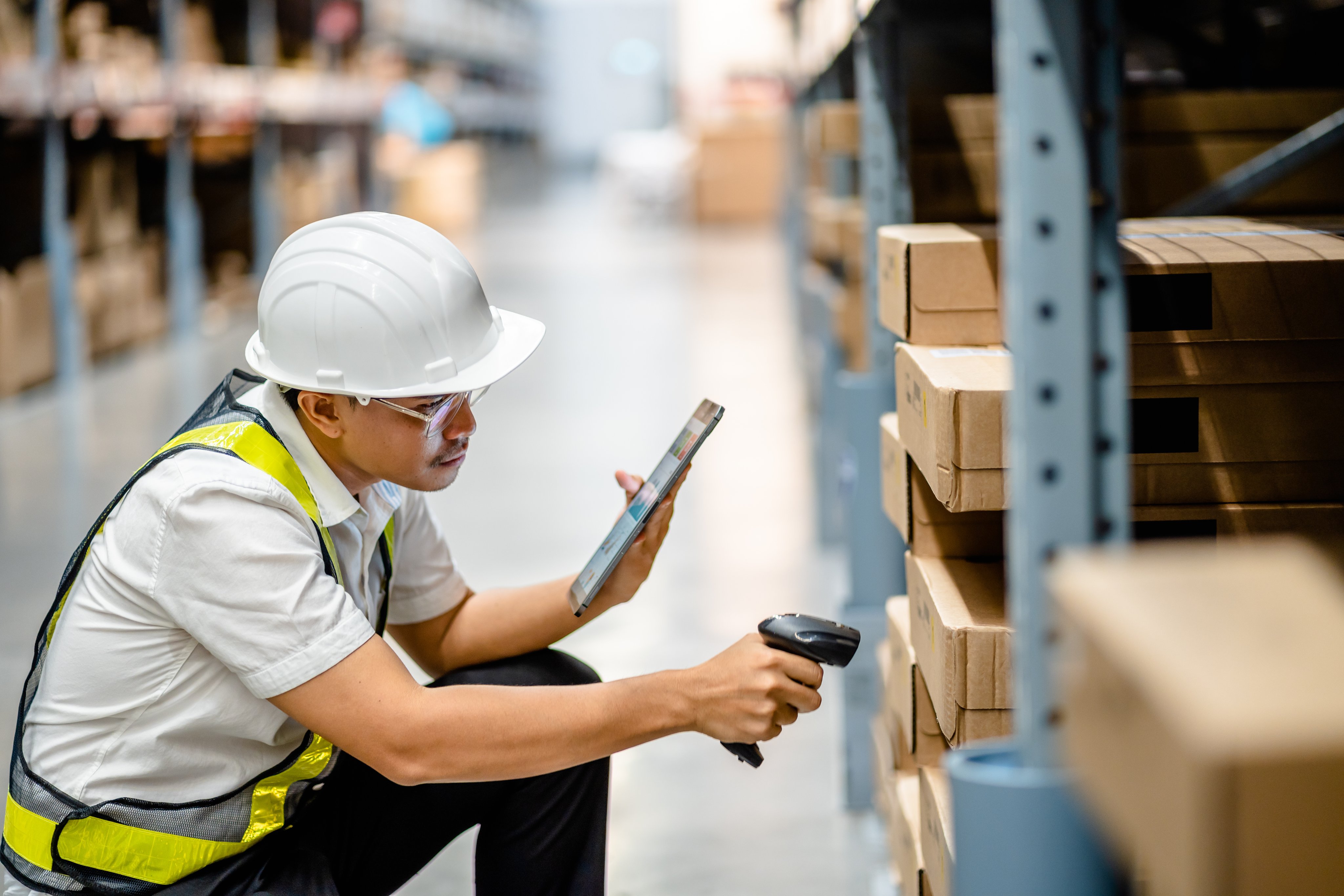 Warehouse workers use scanner checking and scan the barcode of stock inventory to keep storage in a system, Smart warehouse management system, Supply chain and logistic network technology concept.