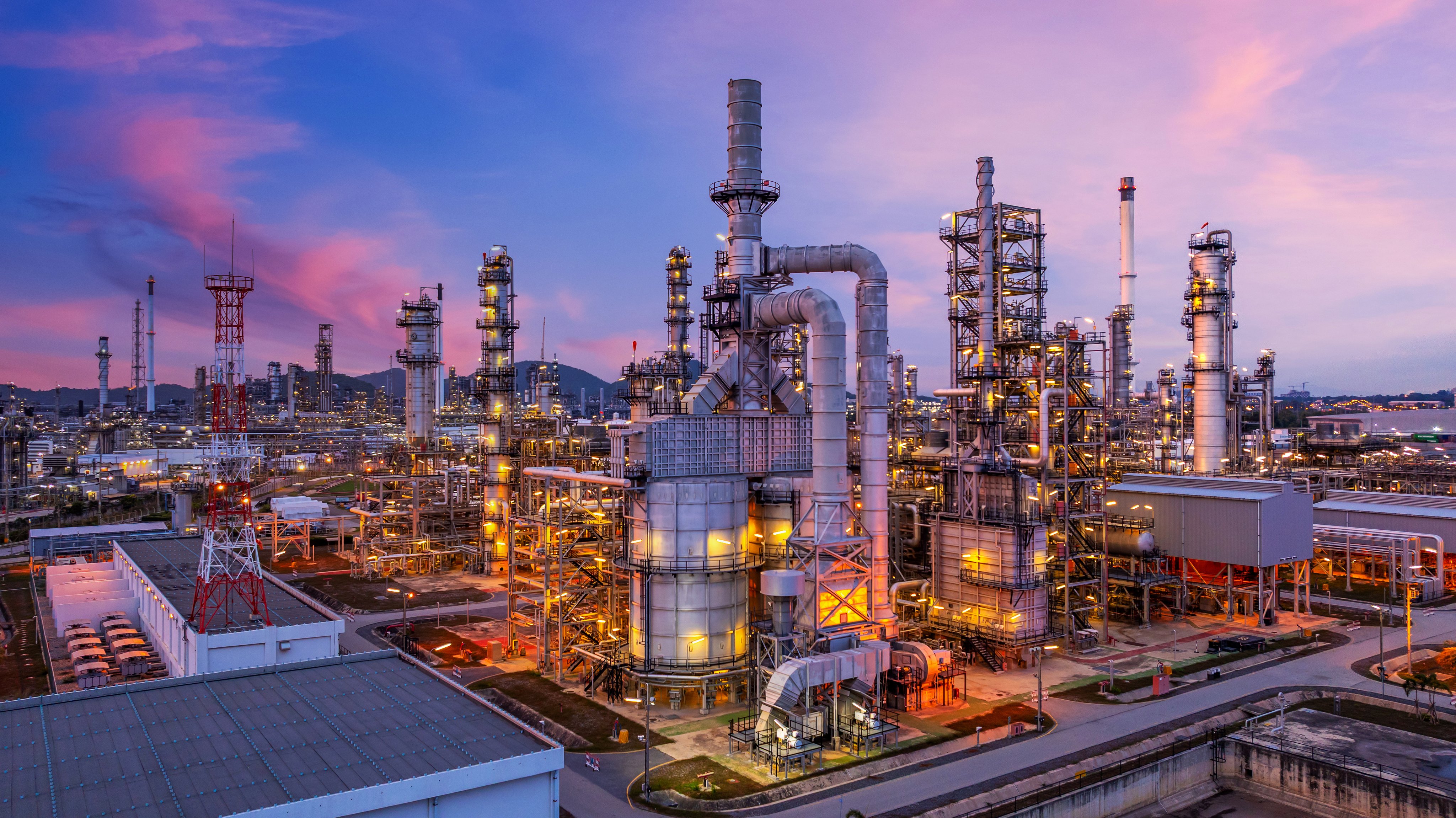 Aerial view oil and gas refinery plant at night, Global business energy logistic transportation, Oil and gas refinery petrochemical industrial, Petrochemical refinery industrial energy supply chain.