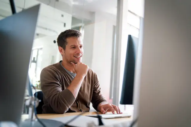 Programmer, web developer, designer working at office comparing mobile and desktop website versions. Business people concept.