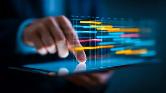 Professional managing colorful project timeline on tablet with gantt chart visualization
