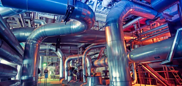 Equipment, cables and piping as found inside of a modern industrial power plant                       