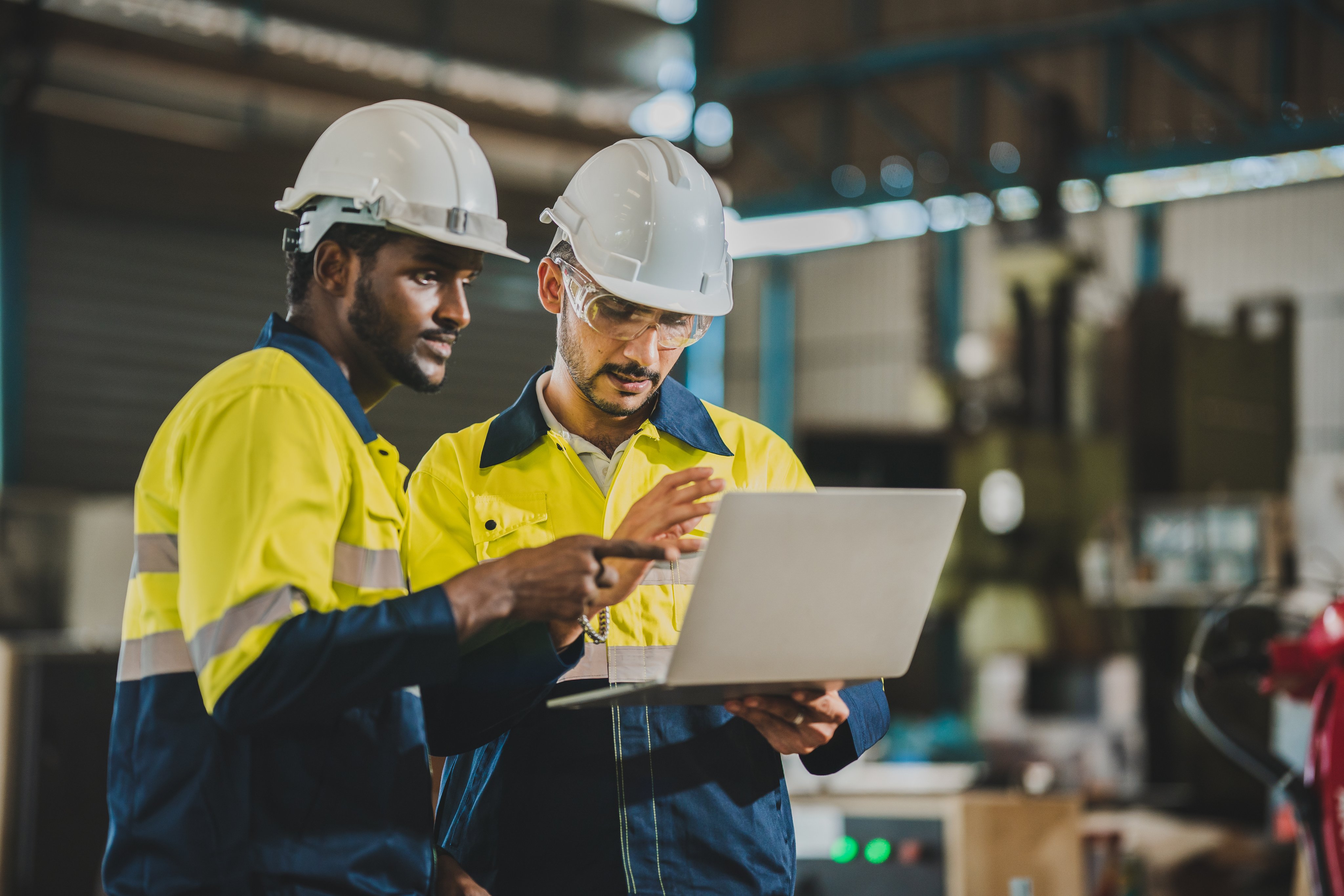 professional technician engineer with safety helmet hard hat working in industrial manufacturing factory, men at work to checking equipment of machinery production technology or construction operating