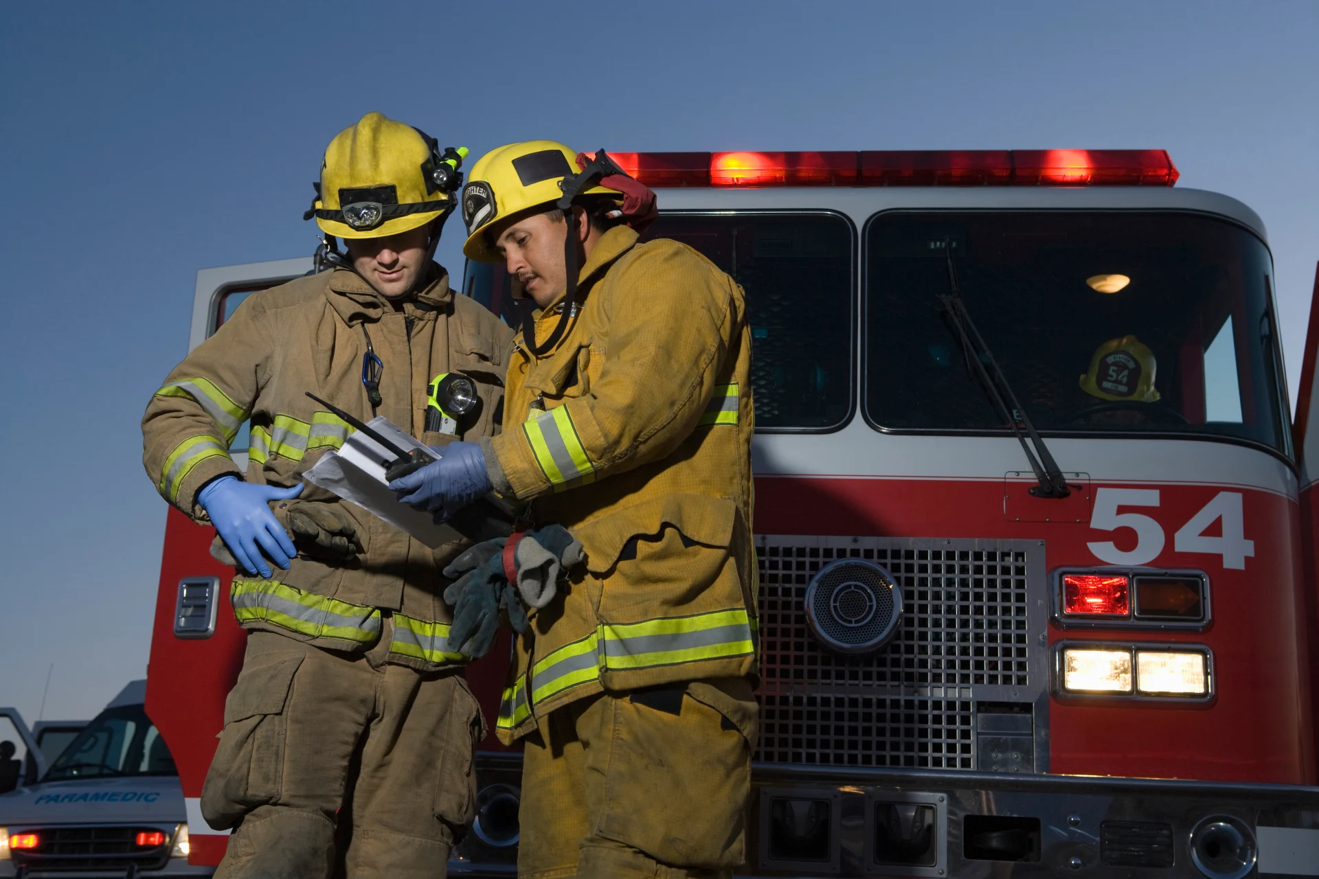 Firefighters planning rescue by fire engine
