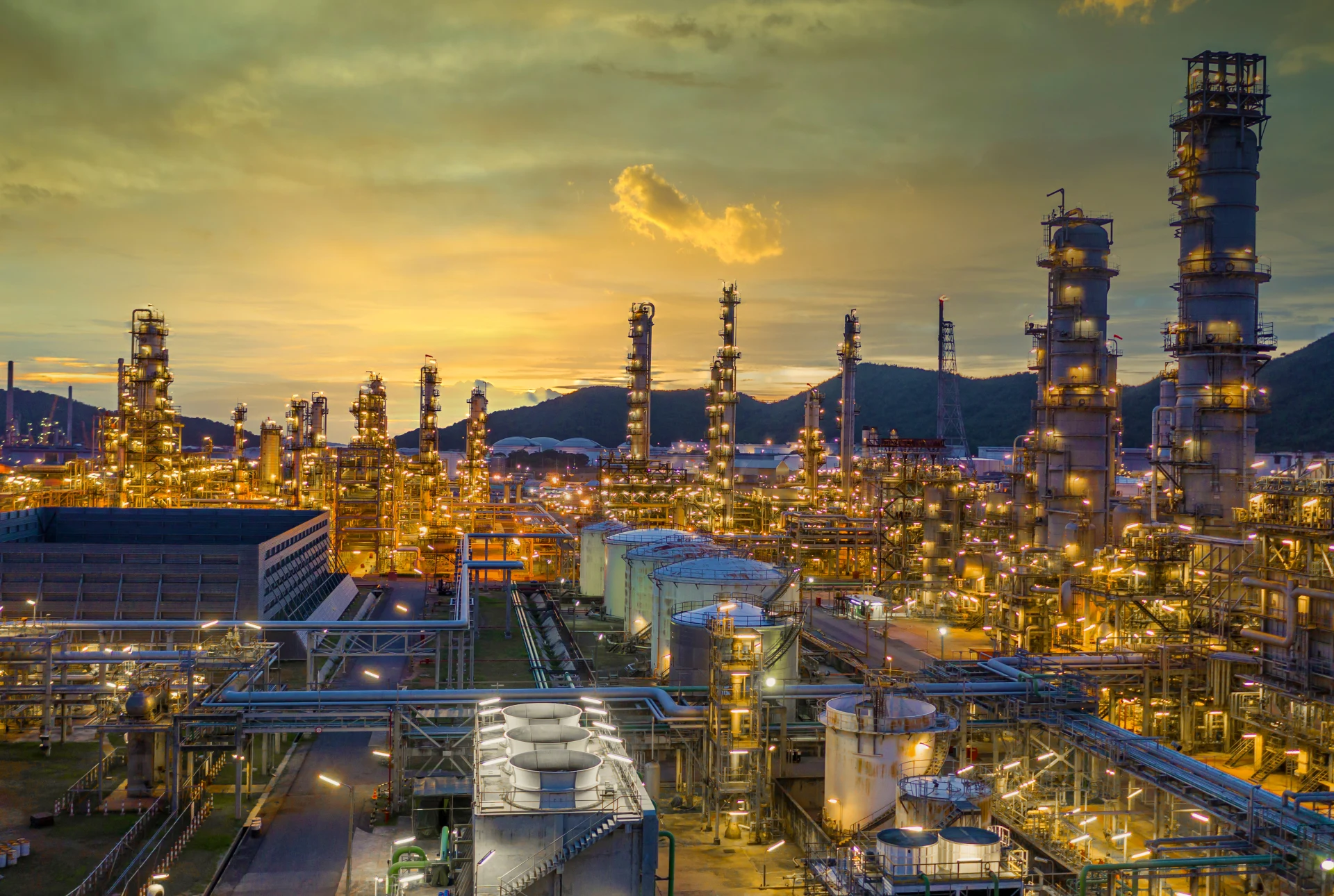 Oil and gas refinery plant form industry zone at night, Aerial view oil and gas Industrial petrochemical fuel power and energy.