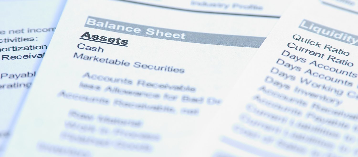 Financial documents with focus on a word "Assets. Very easy to shift colours.