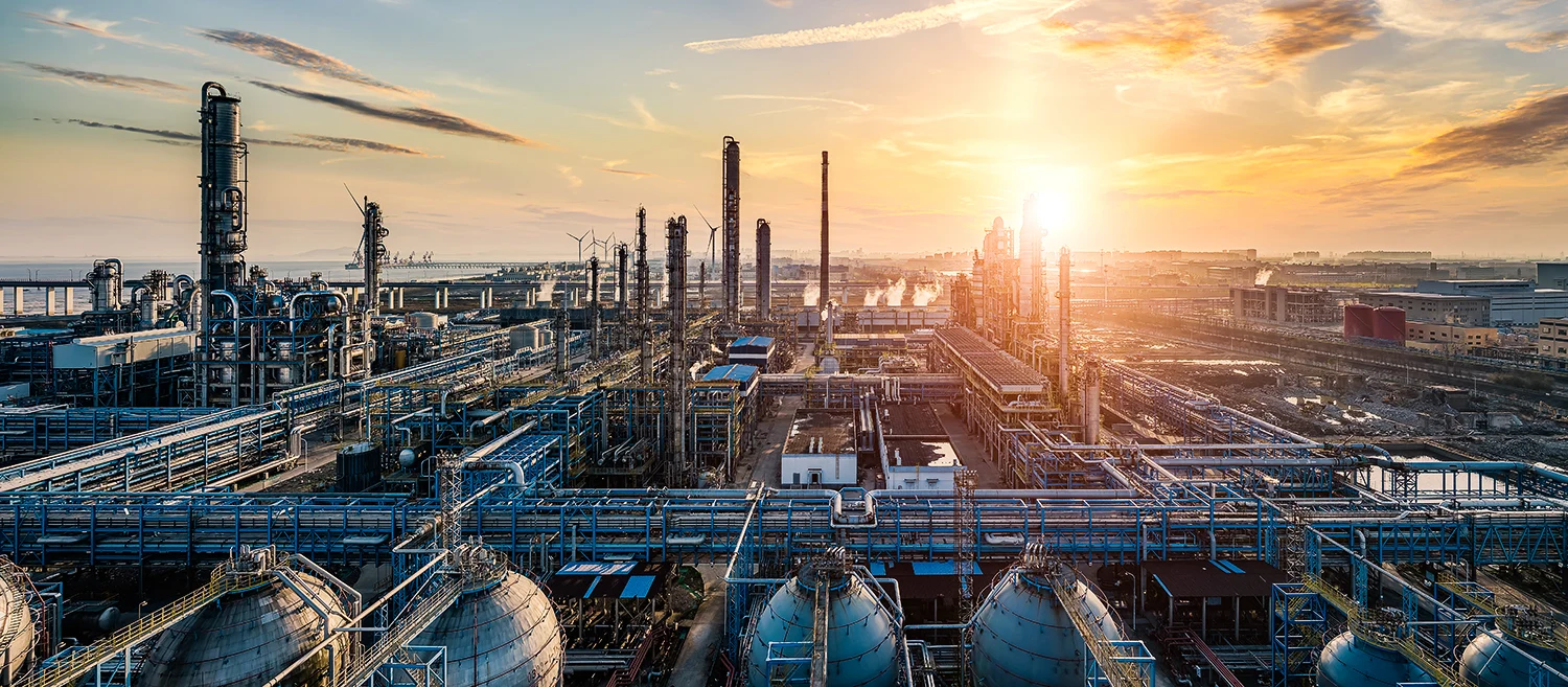 Oil refinery and chemical plant industrial area at beautiful sunset.