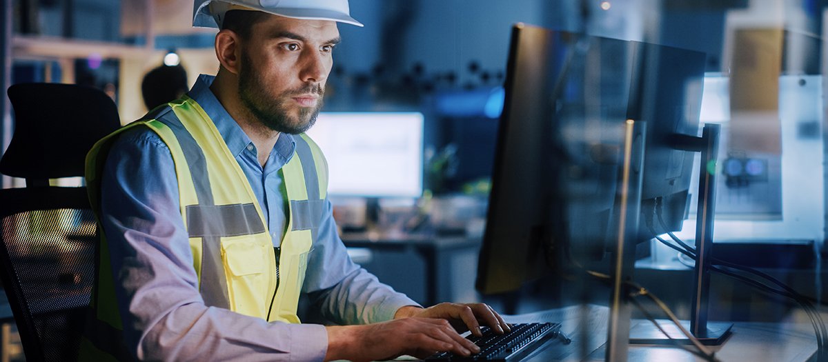 Electronics Design Factory: Portrait of Handsome Male Engineer Wearing Safety Vest Working on Computer, Developing Industrial Microchips, Semiconductor, Manufacturing Processors.
