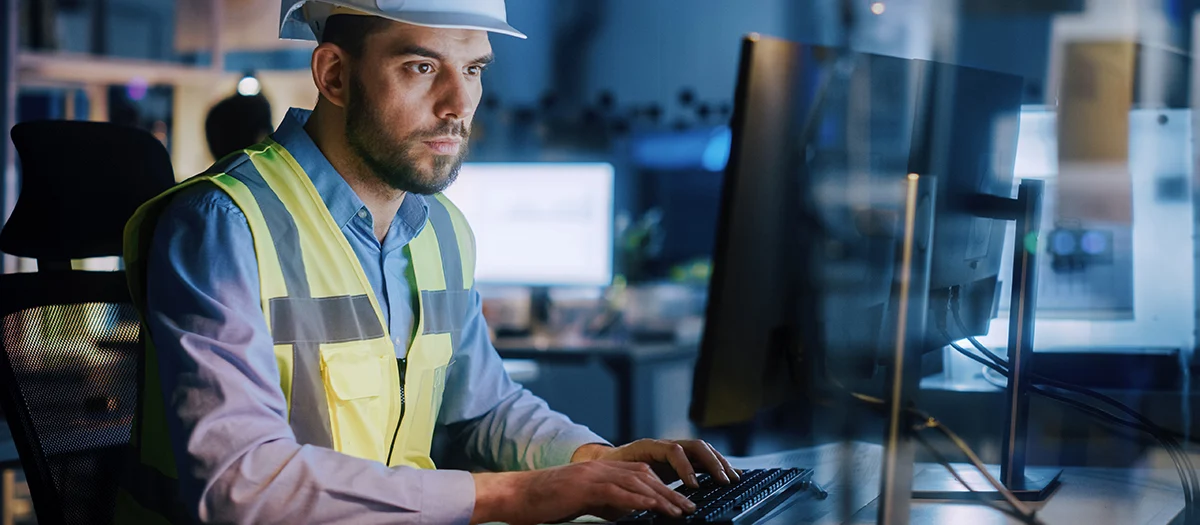 Electronics Design Factory: Portrait of Handsome Male Engineer Wearing Safety Vest Working on Computer, Developing Industrial Microchips, Semiconductor, Manufacturing Processors.