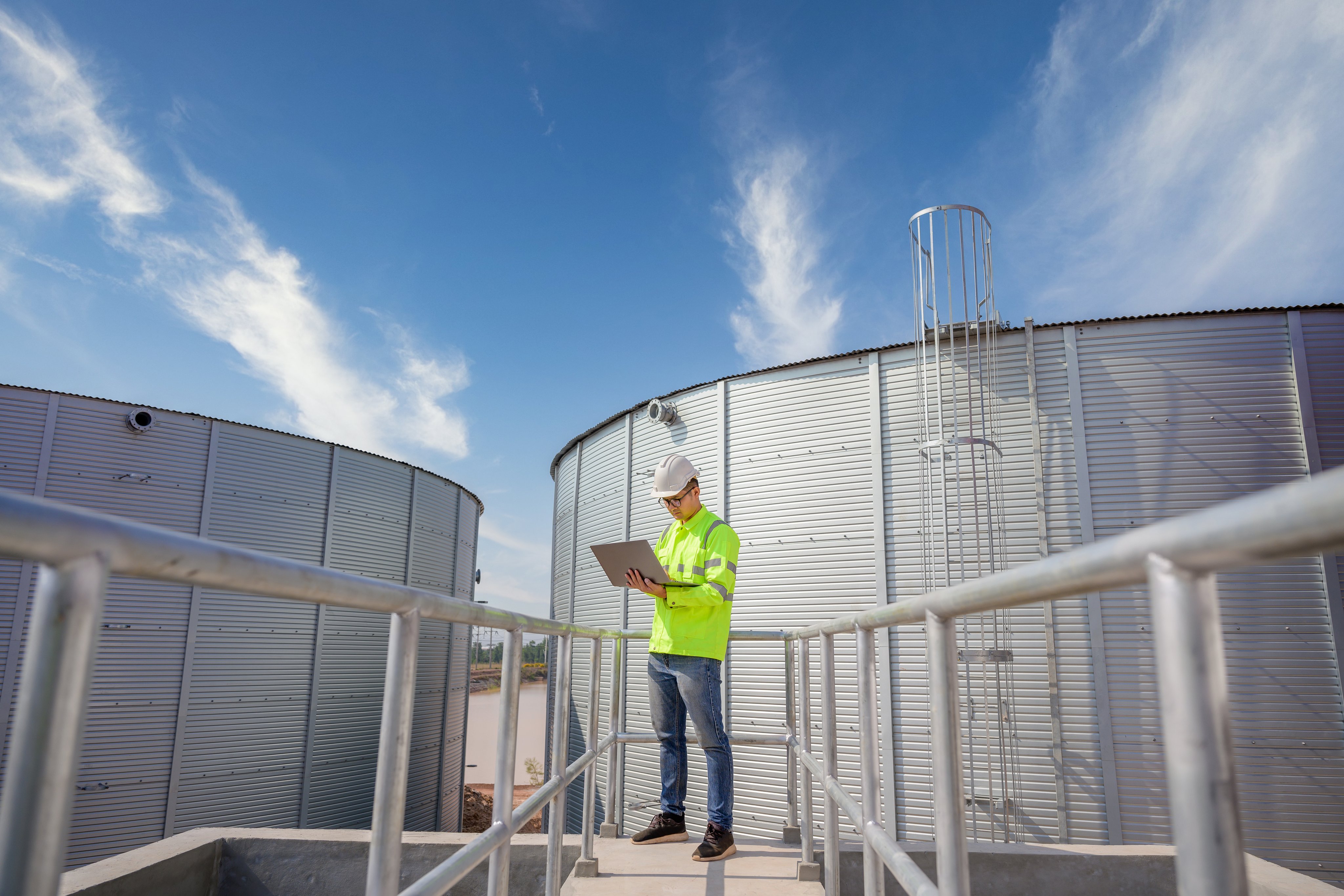 A male industrial engineer is working on designing and managing production in an engineering plant. Utilities and utilities Sewers and central wastewater treatment plants