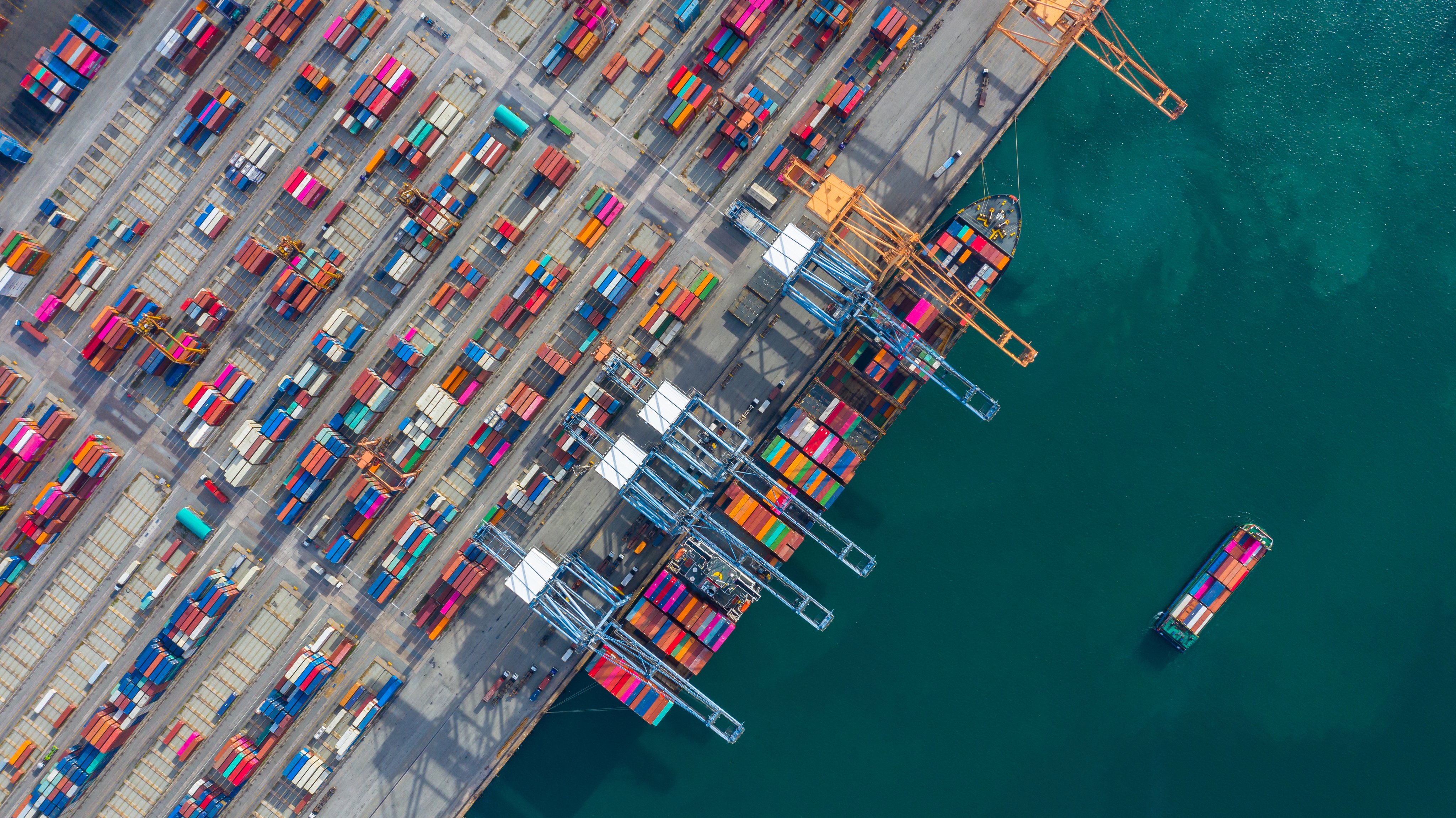 Aerial view cargo ship terminal, Unloading crane of cargo ship terminal, Aerial view industrial port with containers and container ship.