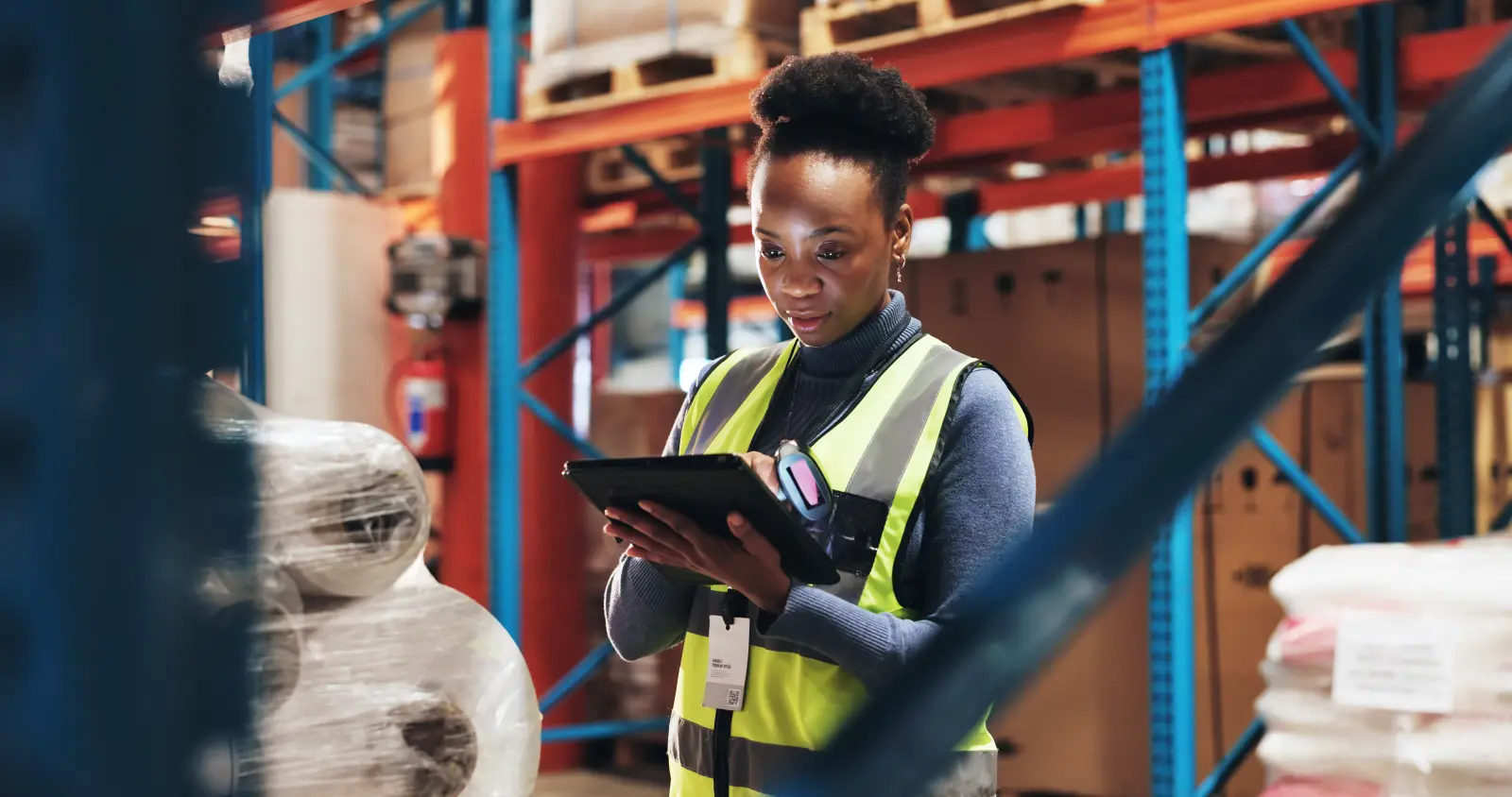 Black woman, inventory and checklist with tablet in logistics for stock control, distribution or inspection at warehouse. Young African, female person or employee checking technology for supply chain.