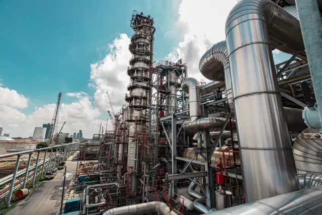Refinery plant equipment for pump pipeline insulation oil and gas valves pressure safety valve selective cloud blue sky.
