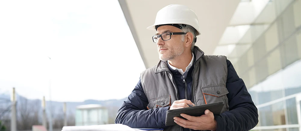 Engineer on site checking project on digital tablet