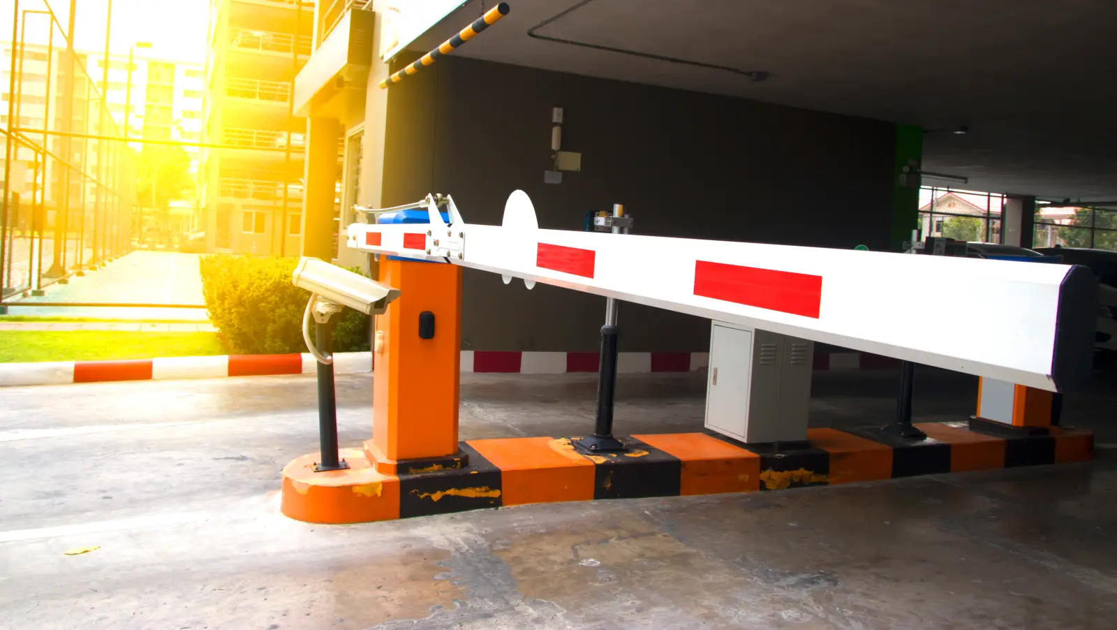 Security system for building access - barrier gate stop with toll booth, traffic cones and cctv