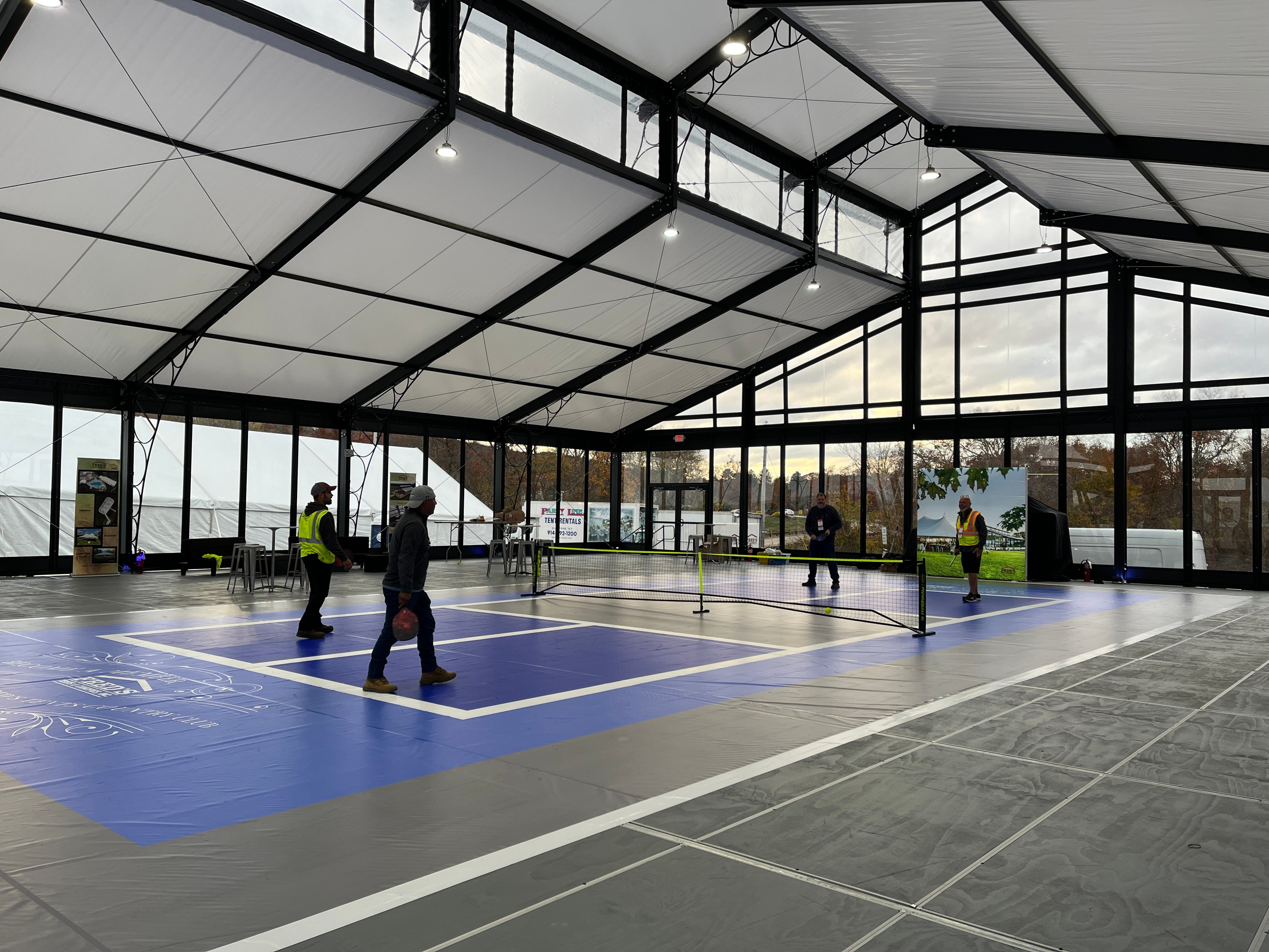 Interior of a tent structure housing a pickleball court
