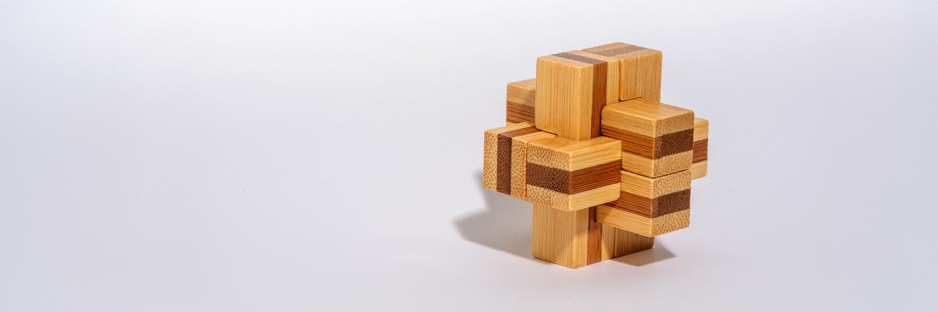 a wooden block puzzle on a white background
